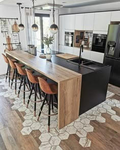 a kitchen with an island and bar stools