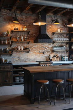 an industrial style kitchen with brick walls and wooden counters, stools at the bar