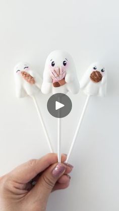 someone is holding marshmallows that look like dogs with noses on them and eyes open