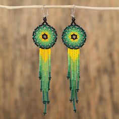 Elaborated with verdant hues of green and yellow a majestic pair of waterfall earrings is handcrafted with petite glass beads. Learning from her parents and grandparents Mexican artisan Adriana Trejo designs this inspiring accessory. Each earring dangles from a hook of sterling silver. Artisan Green Beaded Earrings With Dangling Beads, Artisan Green Beaded Dangling Earrings, Artisan Green Dangle Beaded Earrings, Adjustable Green Chandelier Earrings With Dangling Beads, Green Czech Glass Jewelry With Dangling Beads, Adjustable Green Beaded Chandelier Earrings, Green Beaded Dangle Chandelier Earrings, Green Beaded Teardrop Jewelry, Handmade Green Dangle Chandelier Earrings