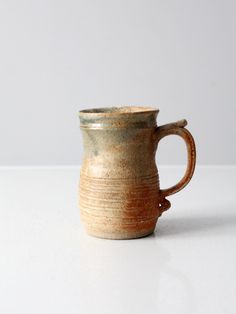 a brown and white cup sitting on top of a table