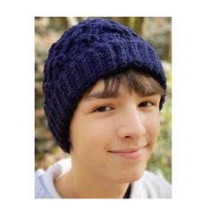 a young man wearing a blue knitted hat