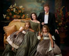 a family posing for a portrait in formal dress