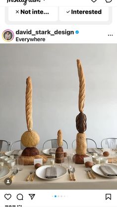 the table is set with bread and pastries on top of each other, as well as two buns sticking out of their heads