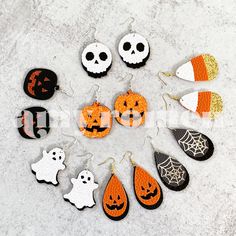 a collection of halloween themed earrings with pumpkins and jack - o'- lanterns