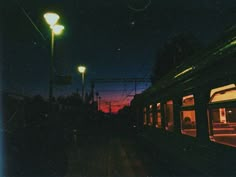 an empty train station at night with the lights on