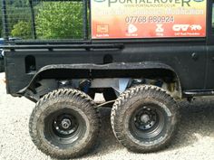 an off - road vehicle is parked in the gravel