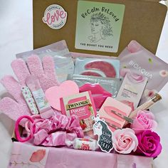 a pink gift box filled with lots of love and goodies for valentine's day