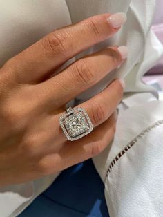 a woman's hand with a diamond ring on it