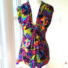 This Beautiful Colorful Printed Top Looks Like The 60's As Far As The Style Of Fabric. In The Middle The Fabric Is Brought Together With A Metal Gold Snake With Red Eyes. The Is The Slightest Cap Sleeve. The Top Measures Pit To Pit 19". Waist 16.5", And Length Of Top Is 25". Washing Instructions Are Hand Wash Gently. The Fabric Is 95% Polyester And 5% Spandex. Just A Gorgeous Blouse! It's Like Brand New! Multicolor Fitted Retro Tank Top, Fitted V-neck Blouse In Multicolor Print, Fitted V-neck Blouse With Vibrant Print, Chic Fitted Multicolor Tank Top, Fitted Chic Multicolor Tank Top, Fitted Sleeveless Vacation Blouse, Colorful Top With Bold Print For Summer, Colorful Bold Print Top For Summer, Colorful Bold Print Summer Top