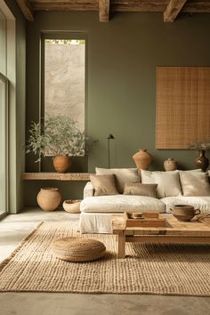 a living room filled with furniture and potted plants