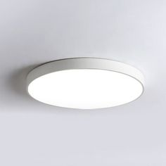 a white circular light fixture on a wall