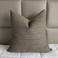 a close up of a pillow on a bed