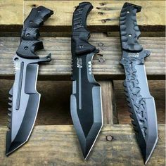 three different types of knifes sitting next to each other on a wooden surface with the blades