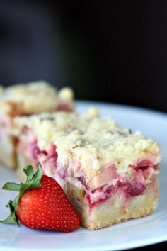 a close up of a piece of cake on a plate with a strawberry