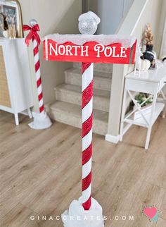 a red and white pole with a sign that says north pole