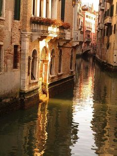 a narrow canal with buildings on both sides