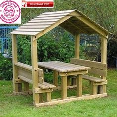 a wooden picnic table and bench in the grass