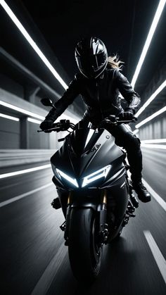 a person riding on the back of a motorcycle through a tunnel with lights coming from behind