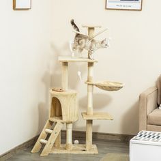 a cat standing on top of a wooden scratching tower in a living room next to a couch