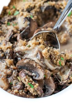 a close up of a plate of food with mushrooms and bread crumbs on it