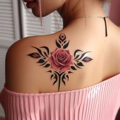 a woman with a rose tattoo on her upper back shoulder and arm, looking down at the ground