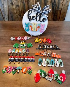 a table topped with lots of magnets on top of a wooden table next to a christmas ornament