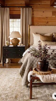 a bedroom with wooden walls and flooring