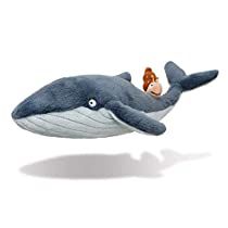 a stuffed toy whale with an acorn on it's nose and tail, floating in the air