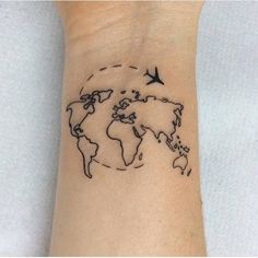 a small wrist tattoo with a world map on it and an airplane flying over the top