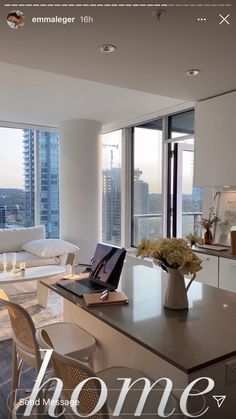 a living room filled with furniture and a laptop computer sitting on top of a table