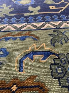 an area rug with blue and green designs on it