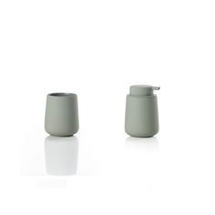 two gray cups sitting next to each other on a white surface