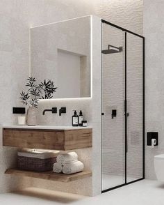 a bathroom with a toilet, sink and shower stall in it's own area