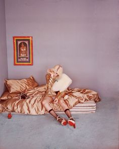 a woman laying on top of a bed in a bedroom