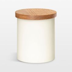 a white jar with a wooden lid