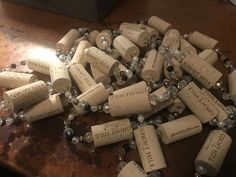 several wine corks are scattered on a table with beads and glass balls around them