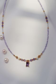 This exquisite necklace featuring a delicate string of amethyst gemstones and radiant freshwater pearls, the centerpiece is a stunning purple CZ amethyst gem framed by intricate gold detailing. Our fine craftsmanship ensures each detail is carefully placed, from the shimmering gold accents to the luminous pearls, making this piece an ideal choice for someone who appreciates refined elegance and unique designs. Treat yourself or a loved one to this beautiful piece today! Details 4*6mm amethyst CZ Elegant Purple Faceted Beads Gemstones, Elegant Purple Crystal Necklace With Gemstone Accents, Elegant Lavender Necklaces With Gemstone Beads, Lavender Amethyst Necklaces For Jewelry Making, Elegant Lavender Crystal Necklace With Round Beads, Elegant Lavender Necklaces With Natural Stones, Purple Amethyst Faceted Bead Crystal Necklaces, Gold Amethyst Single Strand Jewelry, Lavender Crystal Necklaces With Faceted Beads For Gifts