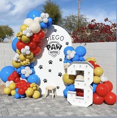 the entrance to diego's paw rescue is decorated with balloons and dog paws on it