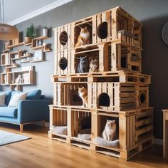 several wooden crates stacked on top of each other in front of a blue couch and coffee table