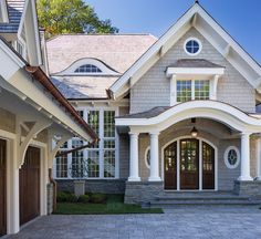 a large house with two car garages in front of it