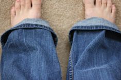 the bottom view of someone's feet and jeans