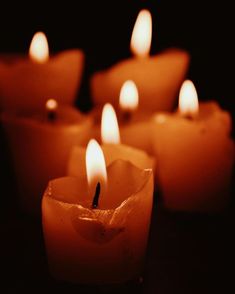 many lit candles sitting on top of a table