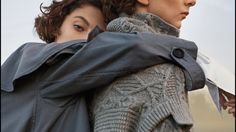 two women are wrapped up in coats