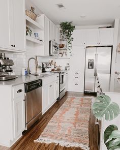 a kitchen with white cabinets and stainless steel appliances is pictured in this image from the front view