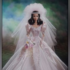 a barbie doll wearing a wedding dress and veil