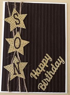 a black and white card with gold foil stars