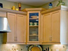 a kitchen with wooden cabinets and green tile backsplash