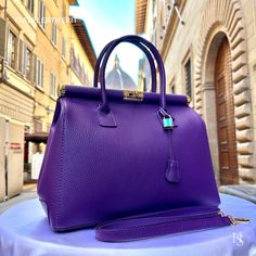 This bag has been made of the best genuine leather by local master crafters of Florence in Italy, designed for women who only accept premium Italian quality and luxury leather bags and modern Italian fashion. . Size: Height: 28 cm/11.02 inches. Width: 33 cm/12.99 inches. Depth: 15 cm/ 5.91 inches. Color: Purple . The story of this bag:  In the heart of Italy, where artistry and craftsmanship have flourished for centuries, a group of skilled artisans pours their passion into creating exquisite le Luxury Purple Satchel, Luxury Everyday Purple Bags, Luxury Purple Bags For Everyday Use, Luxury Purple Shoulder Bag For Office, Purple Soft Leather Bag, Luxury Satchel With Smooth Grain For Shopping, Modern Purple Leather Satchel, High-end Bag For Everyday Use, High-end Everyday Bag With Smooth Grain