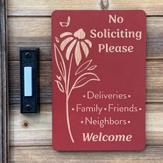 a red sign that says no soliciting please on the side of a door